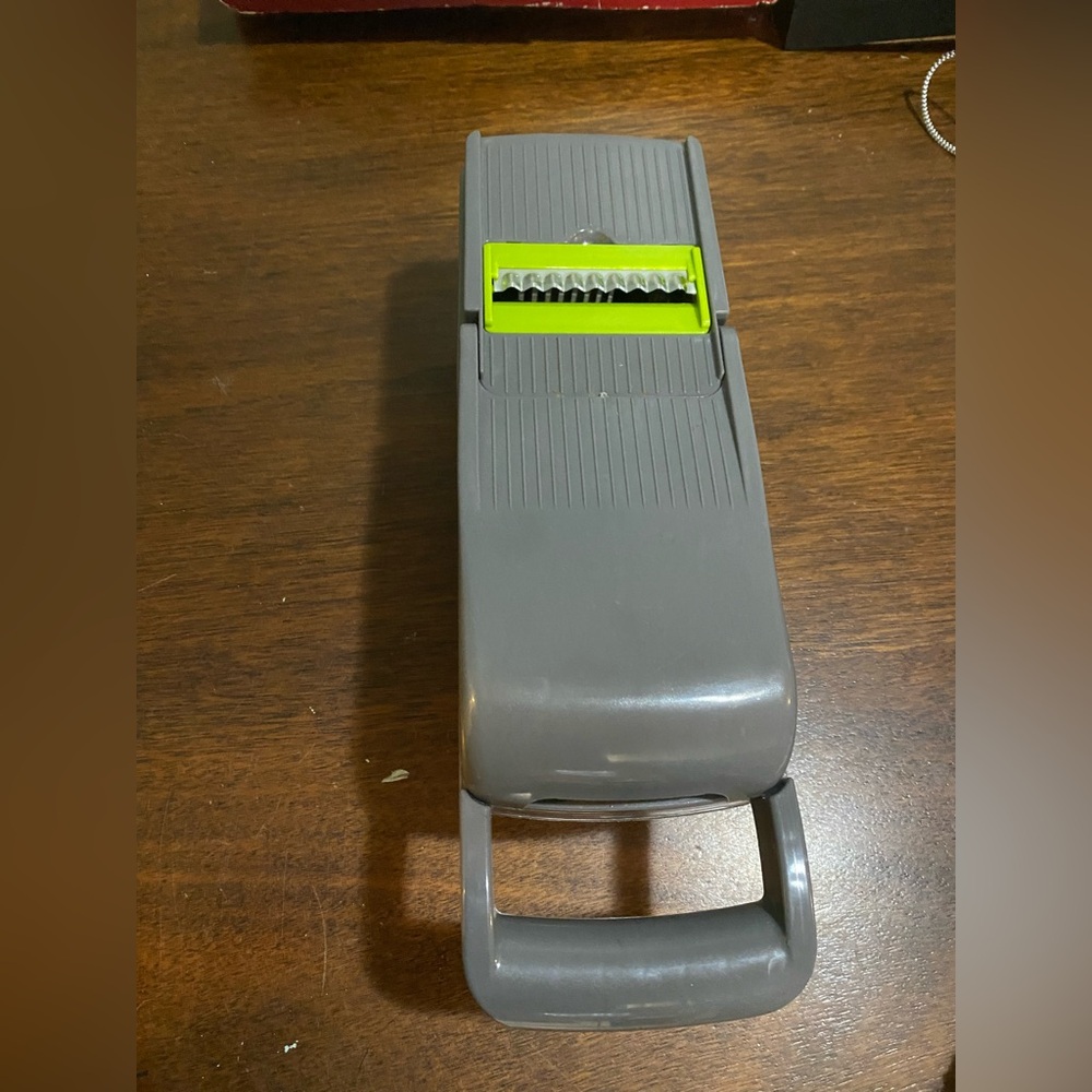 Gray Mandoline Slicer with multiple attachments